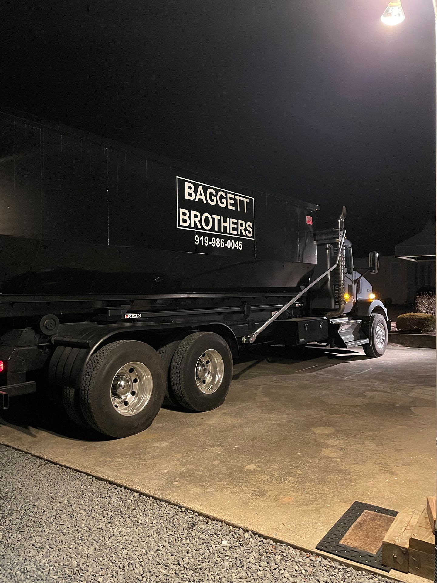 Black Roll-Off Dumpster Rental  in Cary, NC at night