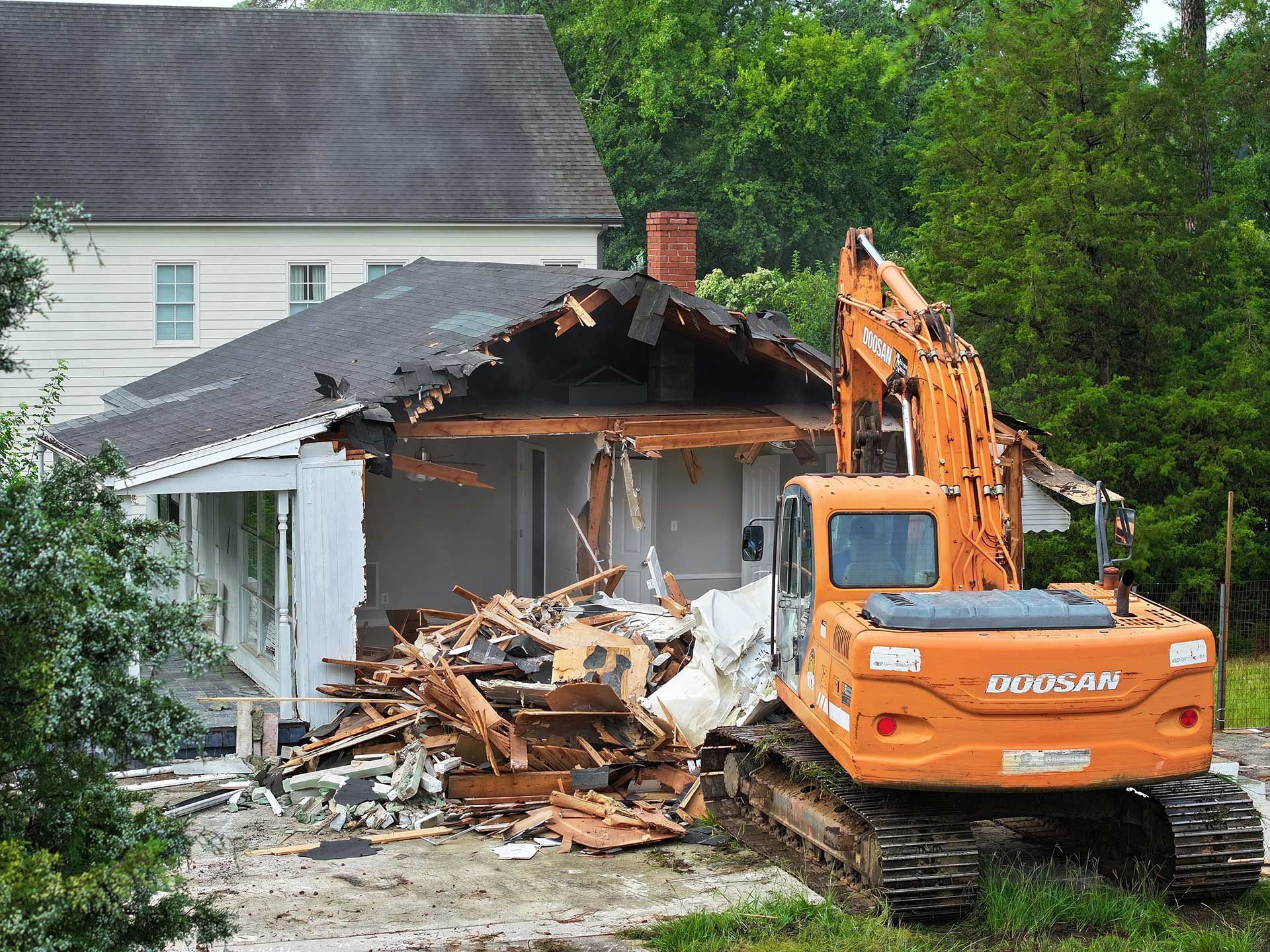 Building demolition contractor tearing a house down