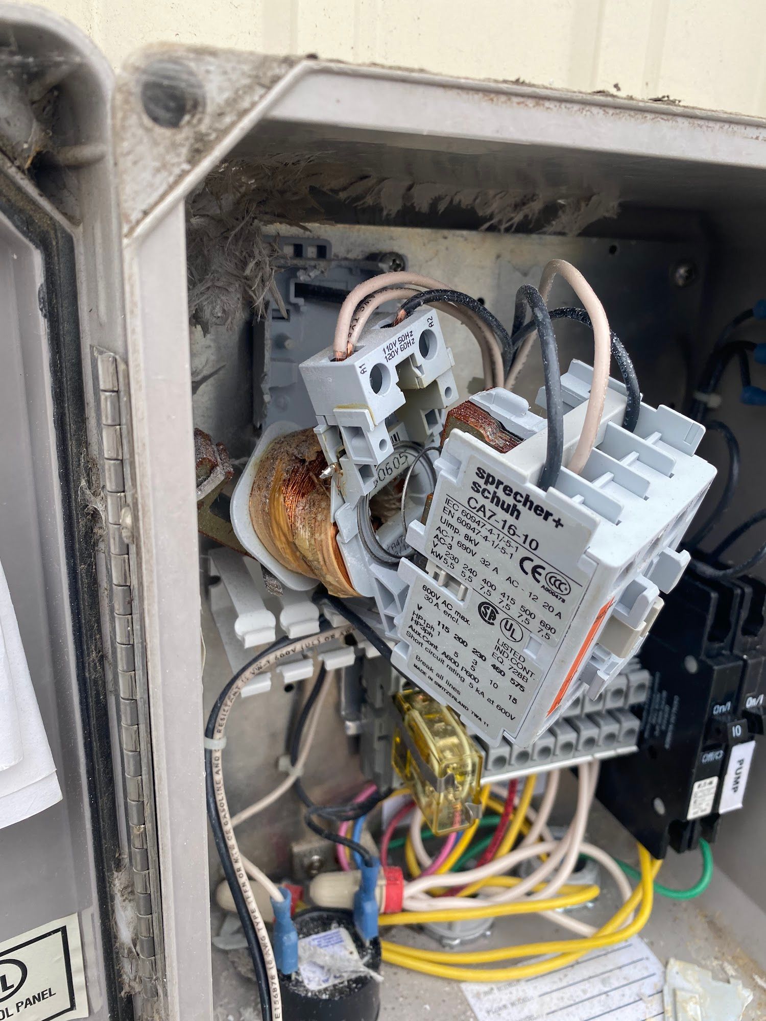Open electrical control box with wiring, relays, and transformer.