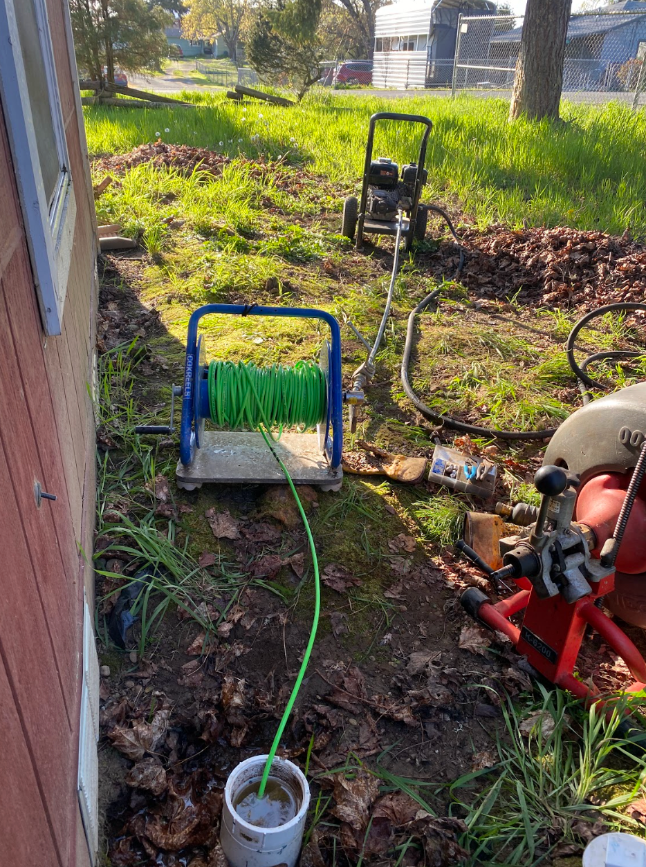 Tesla with a purple and blue iridescent wrap parked in a garage with hexagon lights and a checkered floor.
