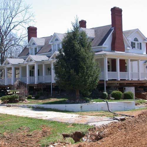 A large house with a tree in front of it
