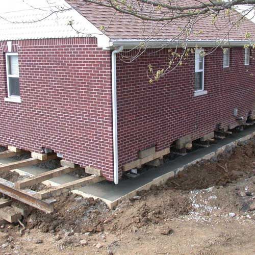 A brick house is being moved to a new location.