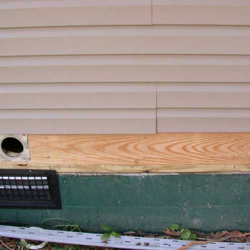 A house with a vent on the side of it.