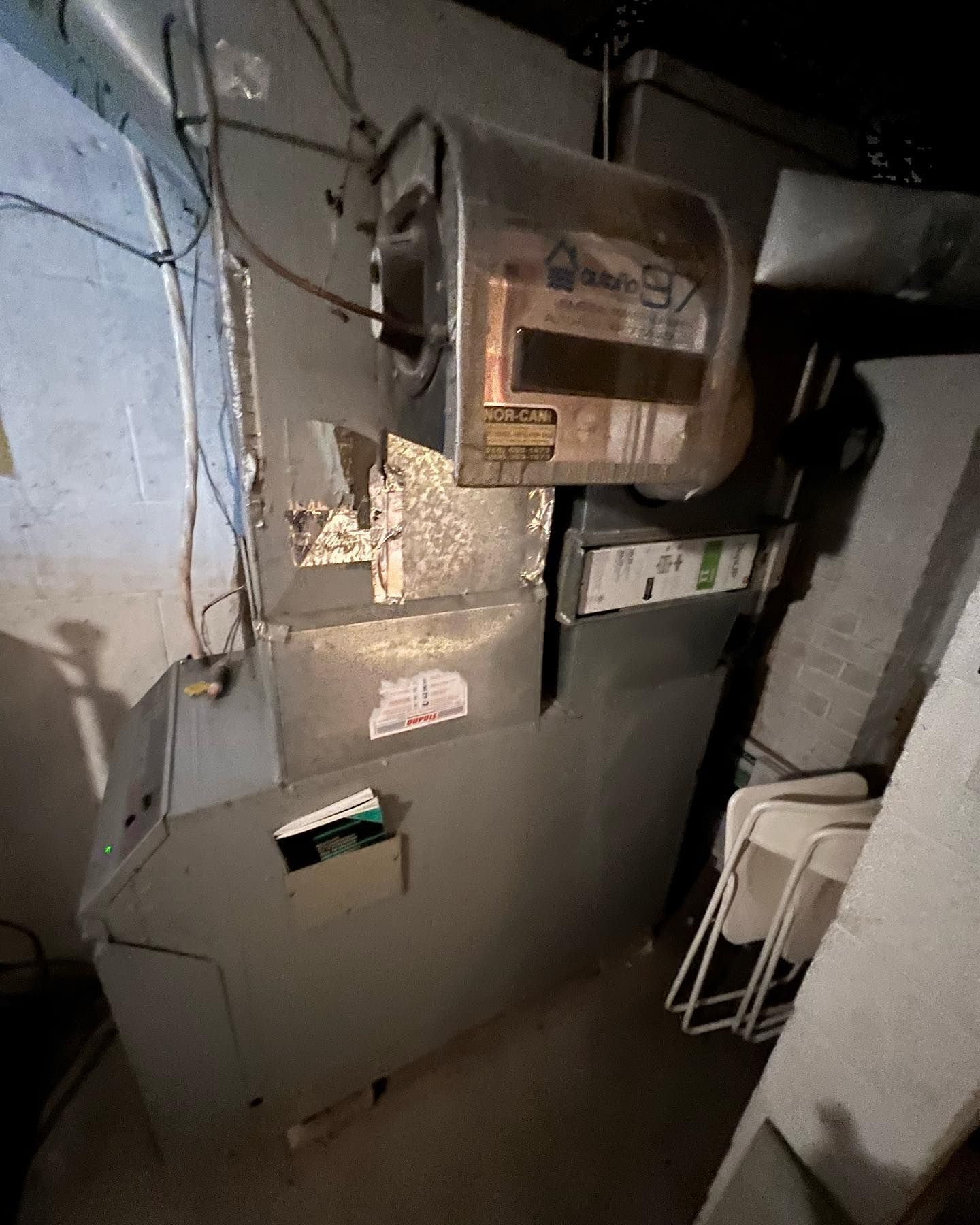 A room with a lot of electrical wires hanging from the ceiling.