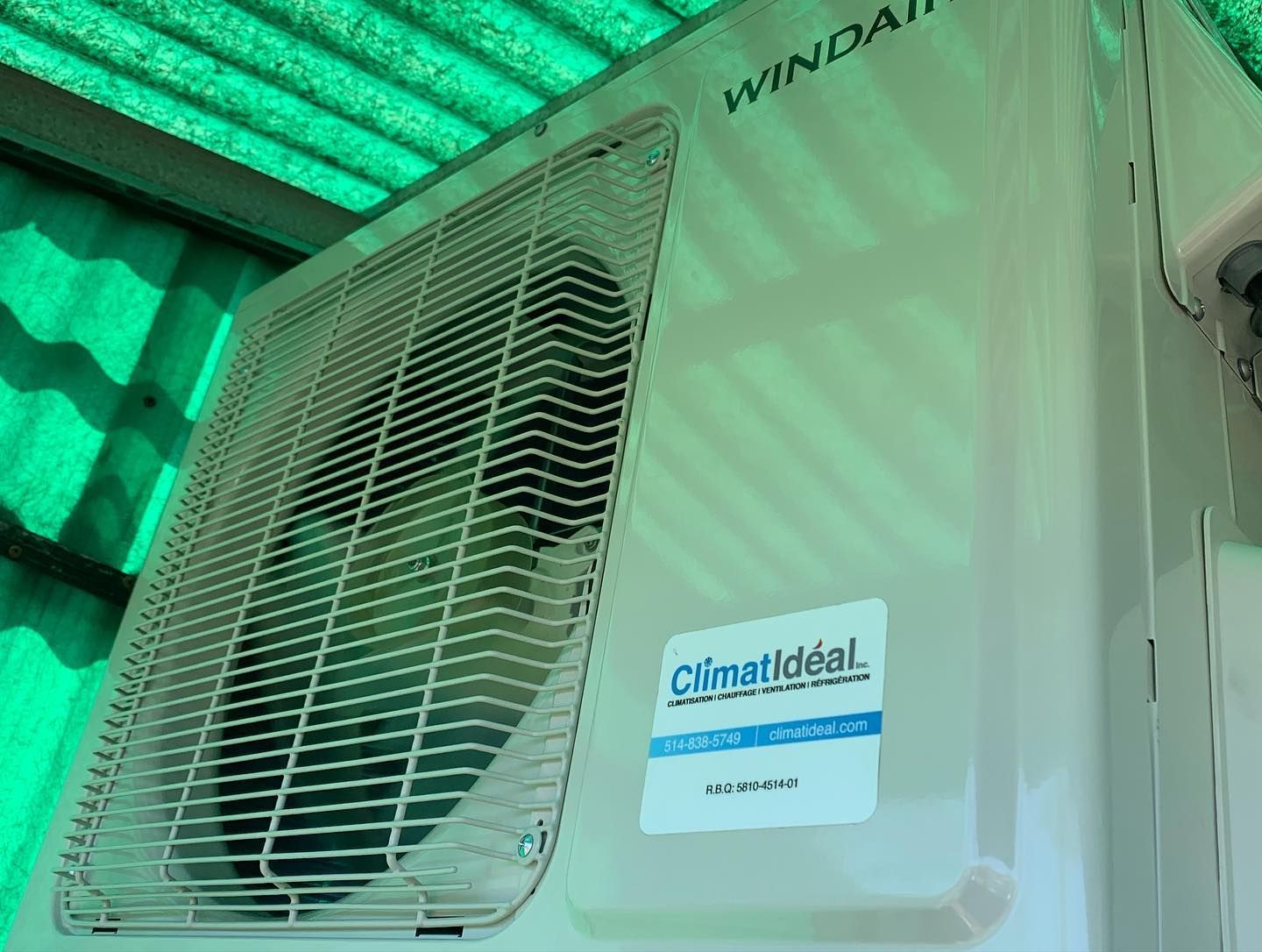 A white air conditioner with a sticker on it that says climaideal