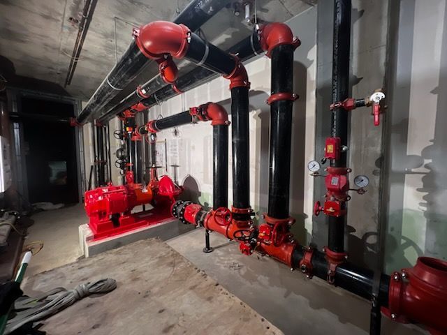 A room filled with red and black pipes and pumps.