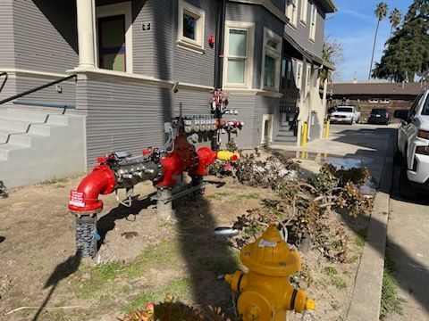 A fire hydrant is sitting in front of a building.