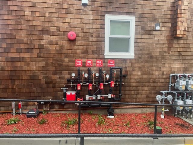 A fire alarm is mounted on the side of a building