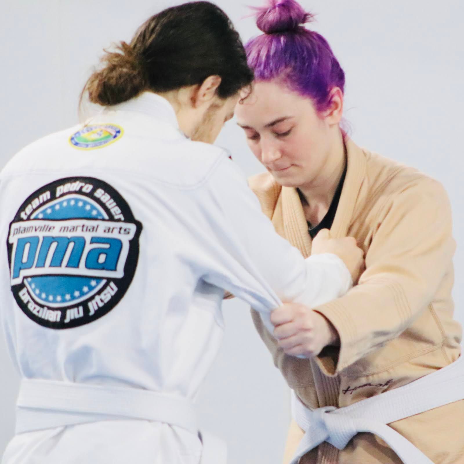 Beginners practice partner drills at Plainville Martial Arts in Plainville, CT, building fitness and calm confidence.