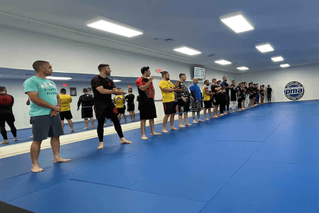 Adults practicing focused pad drills at Plainville Martial Arts in Plainville, CT to relieve stress.