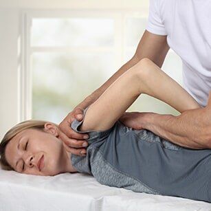 Spine — Woman Having Chiropractic Back Adjustment in Redding, CA