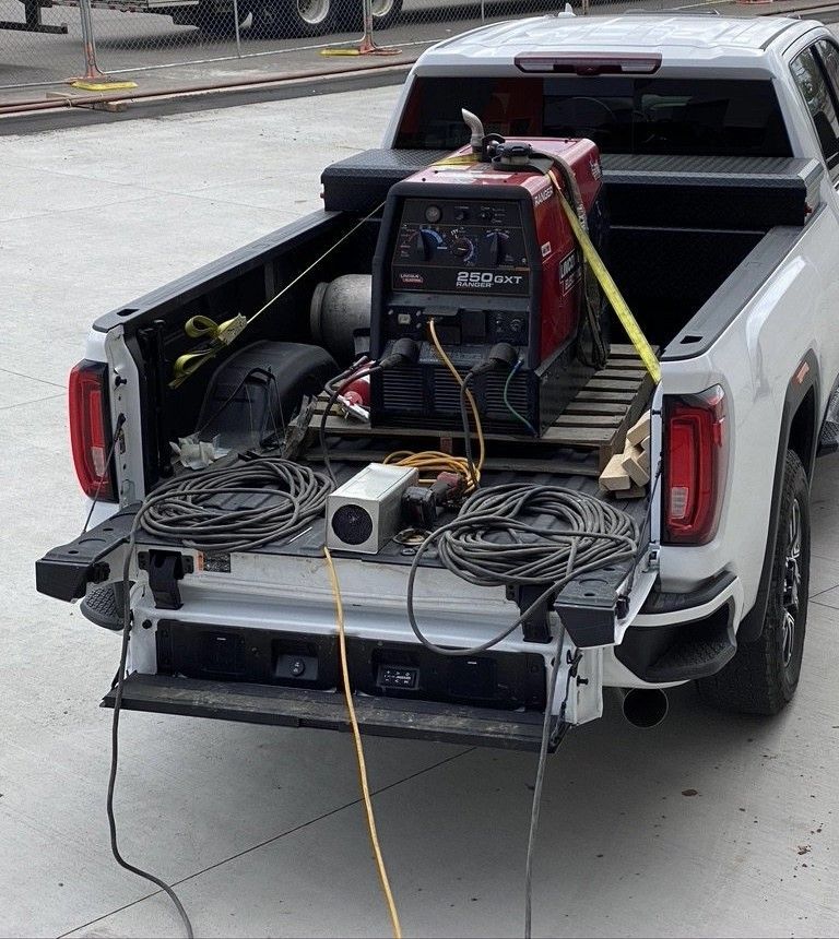 A welding machine is in the back of a truck