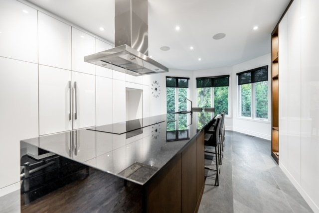 A kitchen with a large island and stainless steel appliances