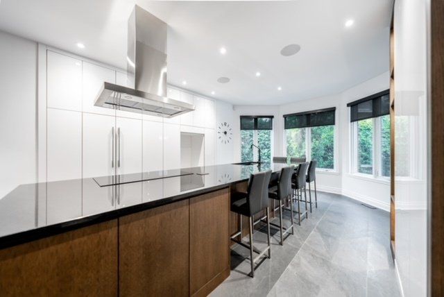 A kitchen with a large island and a stove top oven