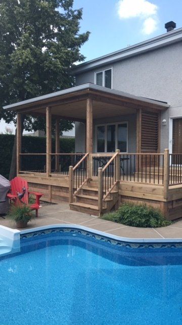 A house with a swimming pool and a wooden deck