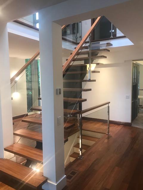 A staircase with wooden steps and a glass railing