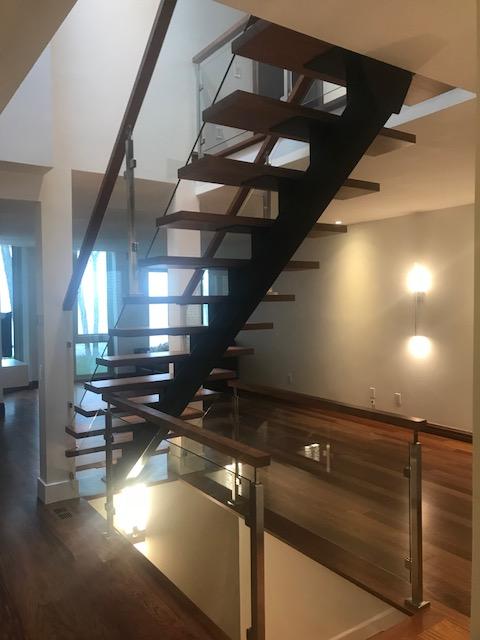A staircase with wooden steps and a glass railing
