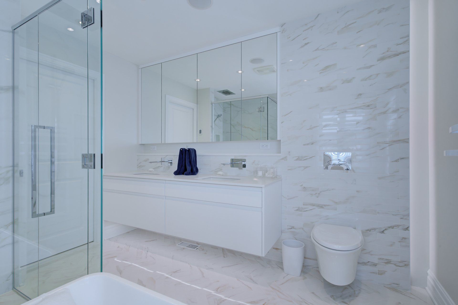 A bathroom with a toilet , sink , and shower.