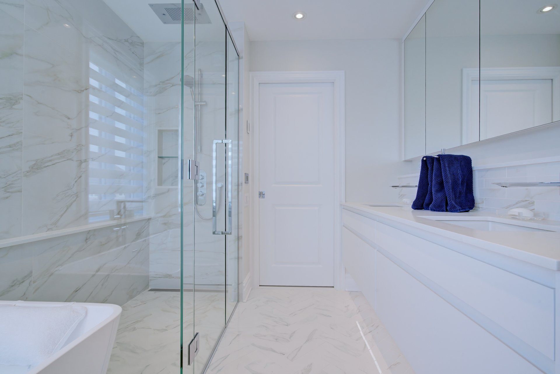 A bathroom with a walk in shower , sink , and bathtub.