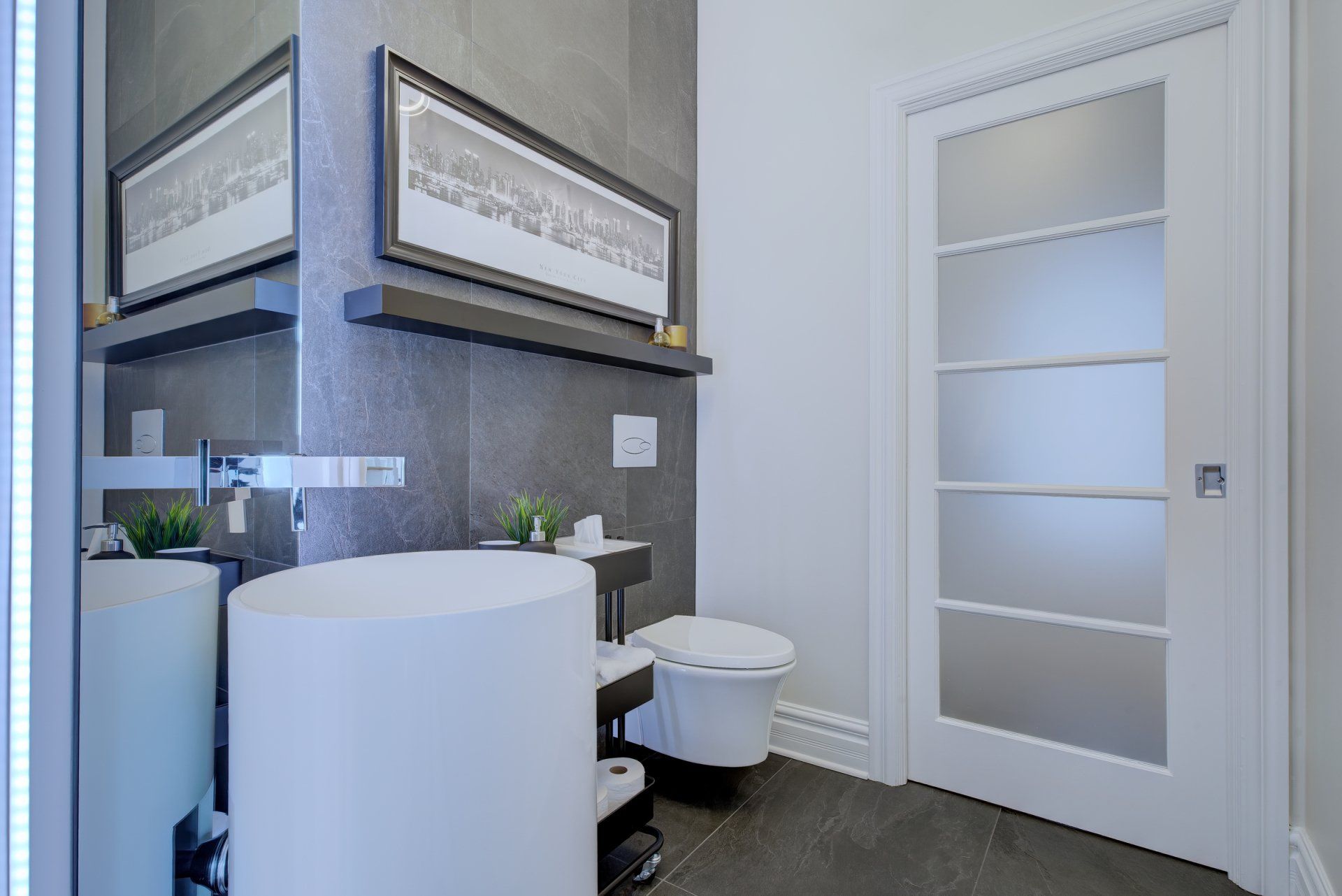 A bathroom with a sink , toilet and mirror.