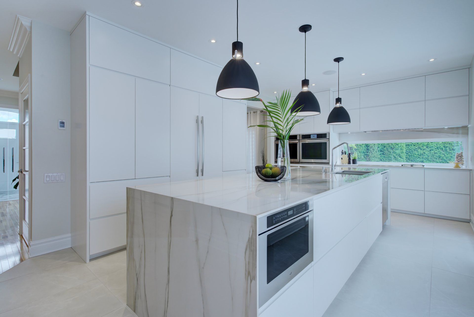 modern kitchen with white marble island and white ceramic flooring
