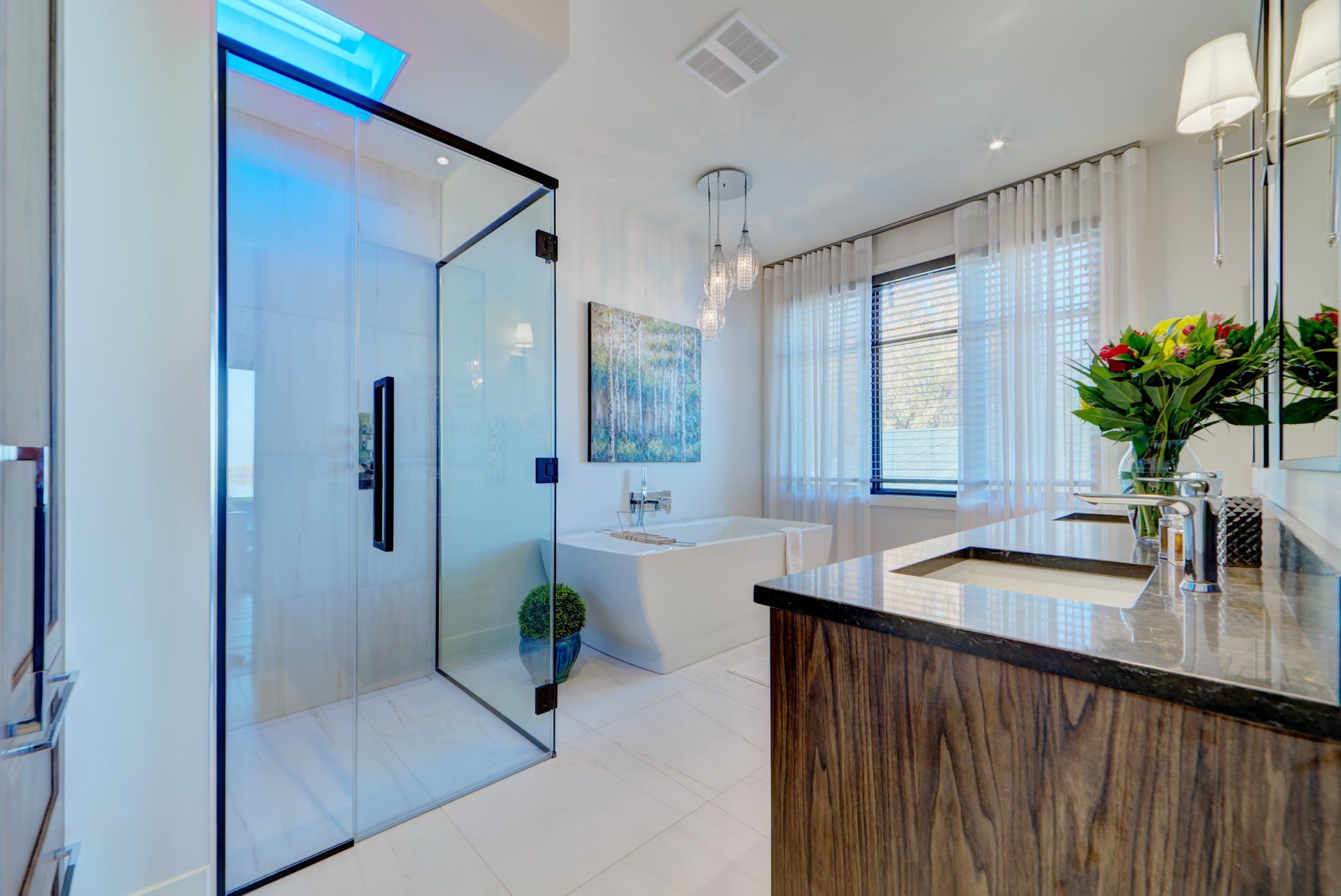 A bathroom with a bathtub , sink , and shower.