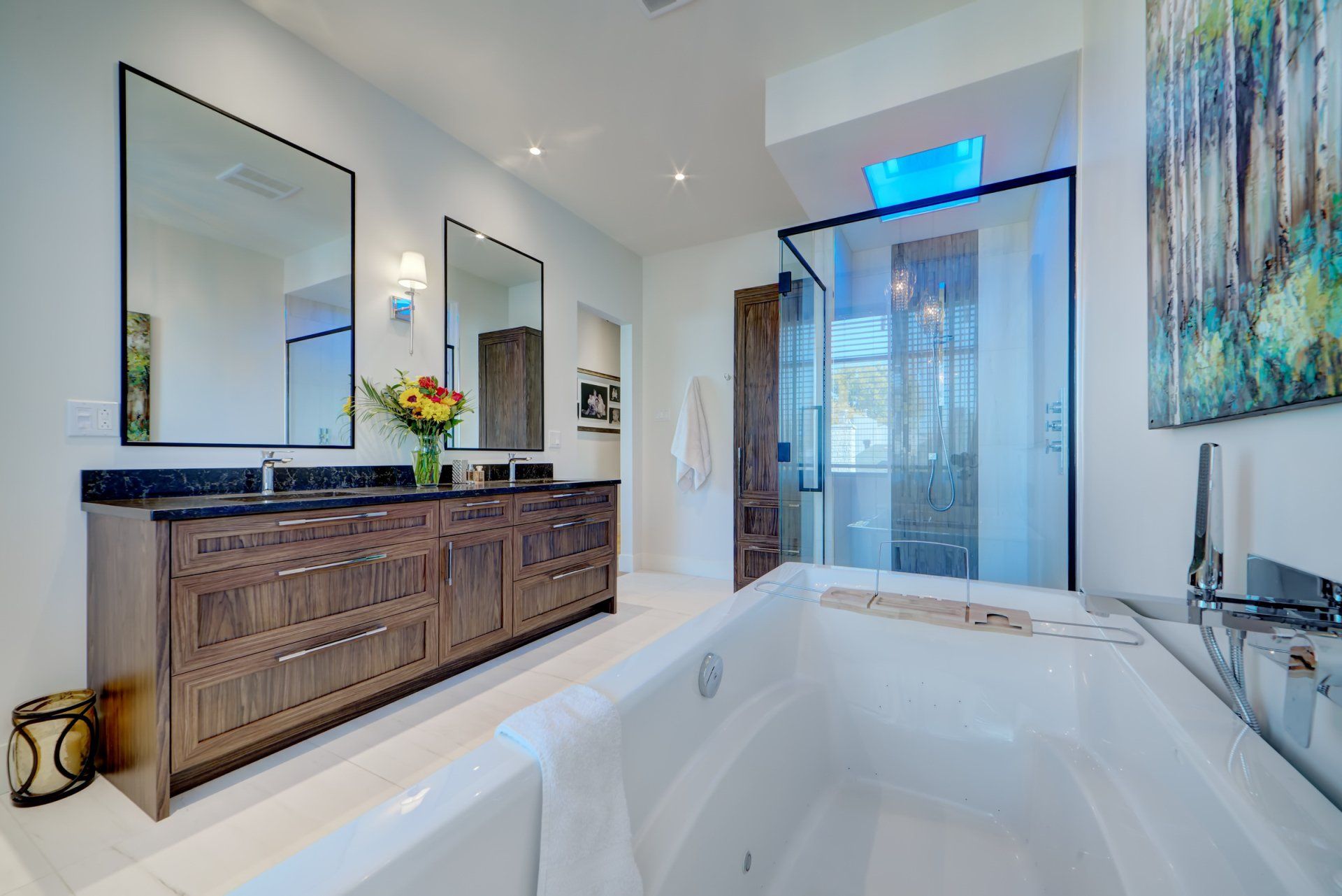 A bathroom with two sinks , a tub and a shower.