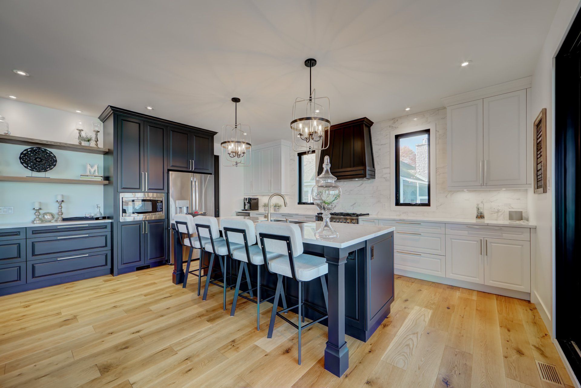 A large kitchen with a large island and stools.