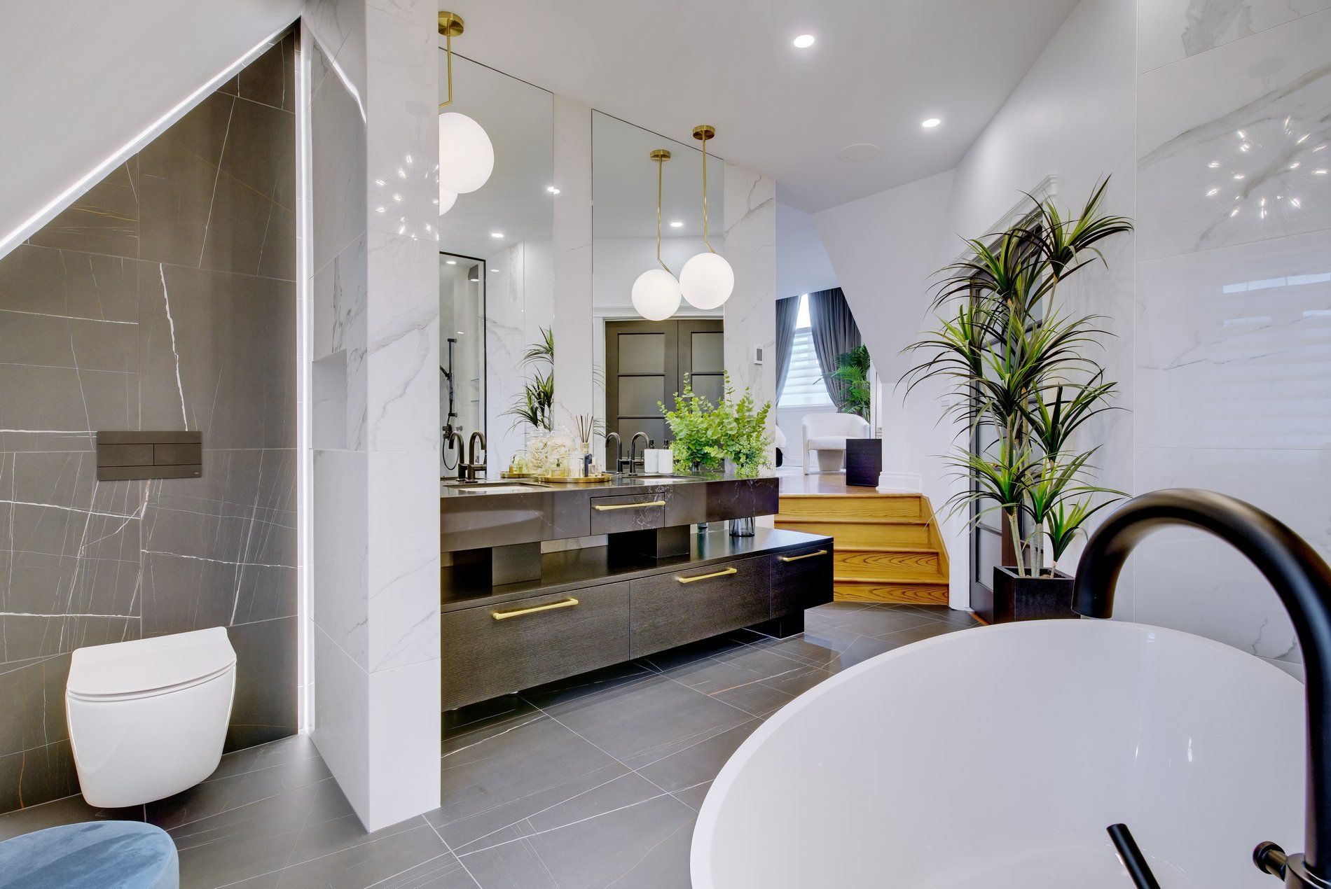 A bathroom with two sinks , a toilet , and a bathtub.