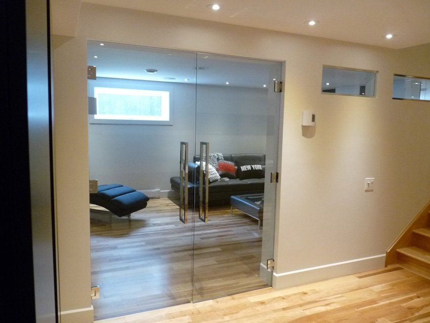 basement with light wood flooring and glass door cabinet