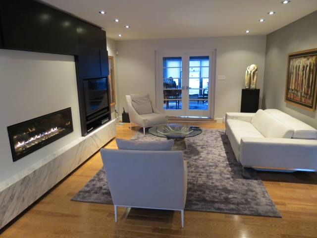 basement with shiny wood floors and modern fireplace