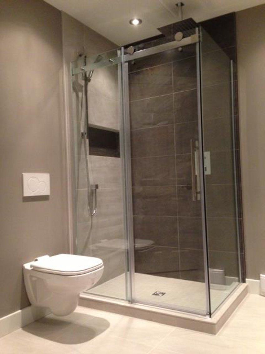 modern glass shower with grey tiles