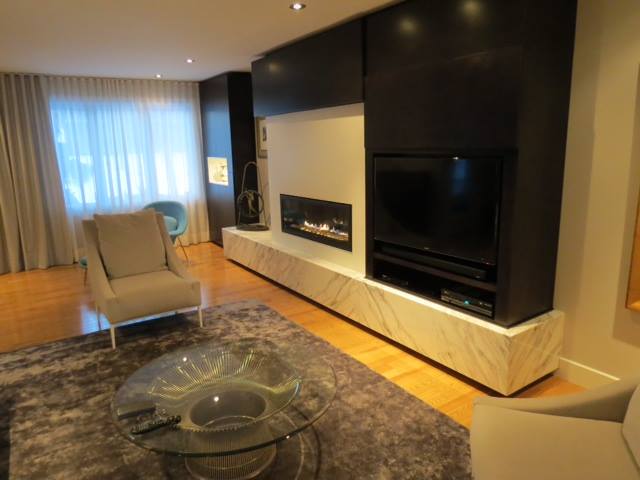 basement with modern white fireplace