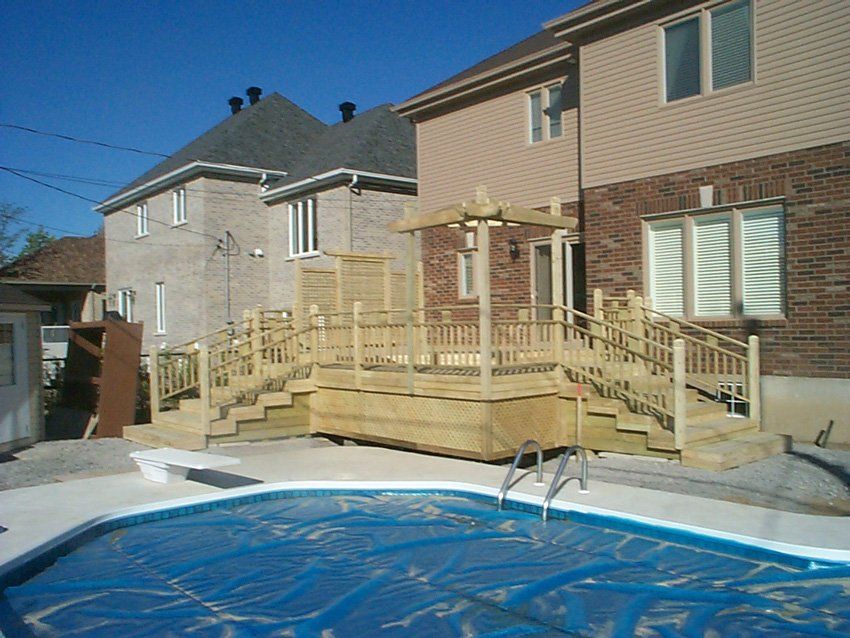 backyard with natural wood patio and pool
