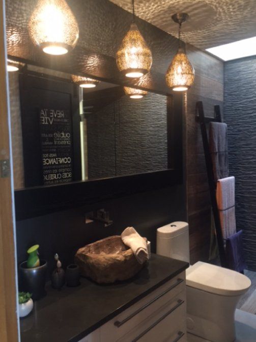 modern bathroom with black countertops and dim lighting
