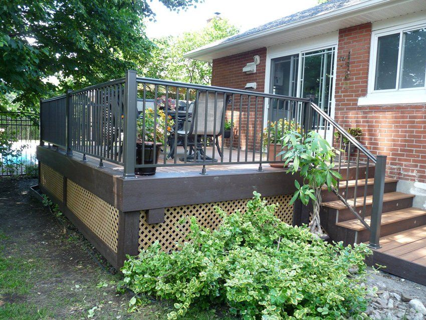 wood patio in backyard with metal railings