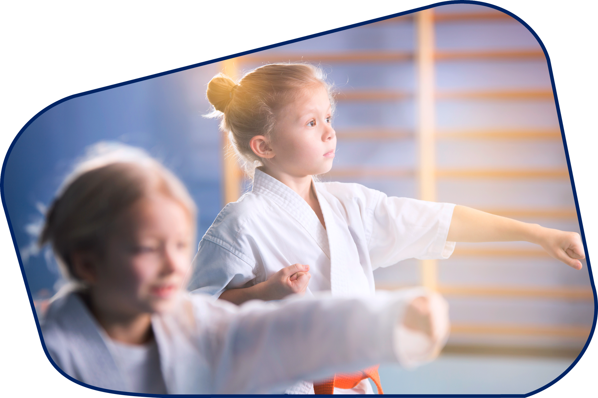 two young girls are practicing karate in a gym .