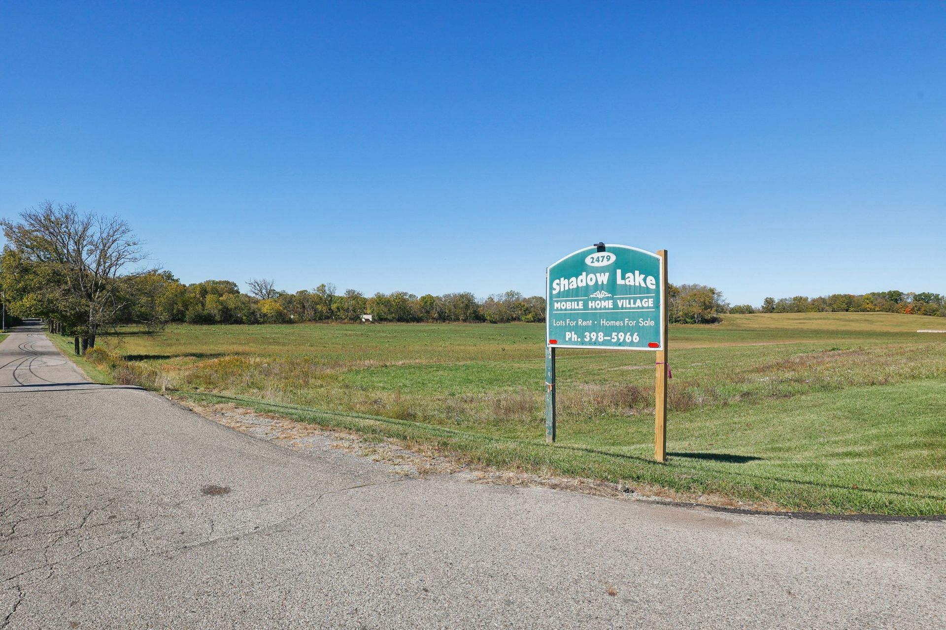 Sign for Ramsey Lake County Park in open field, clear sky.