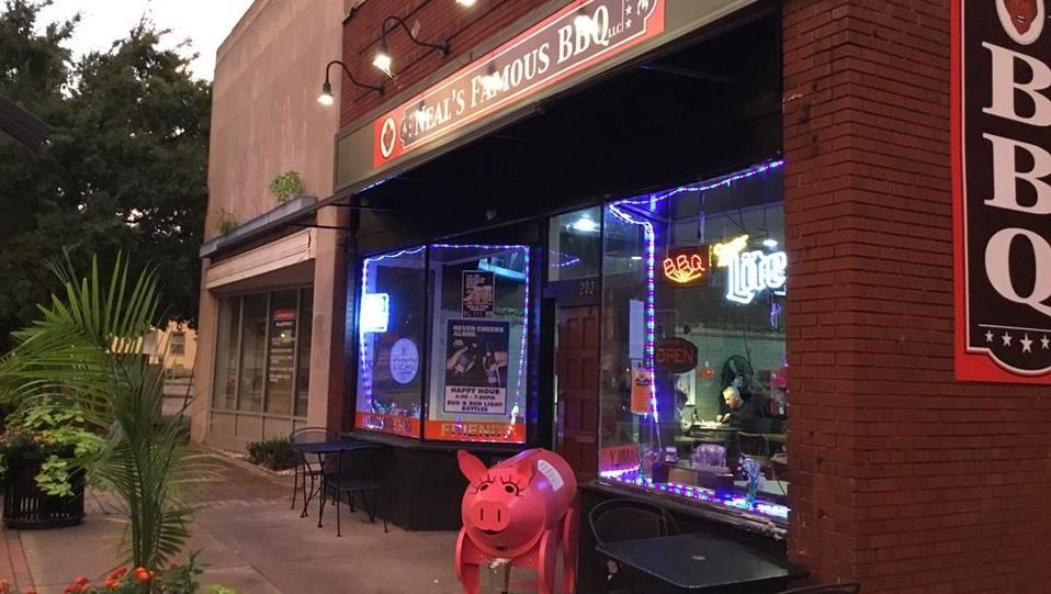 Exterior of Neal’s Famous BBQ restaurant with outdoor seating