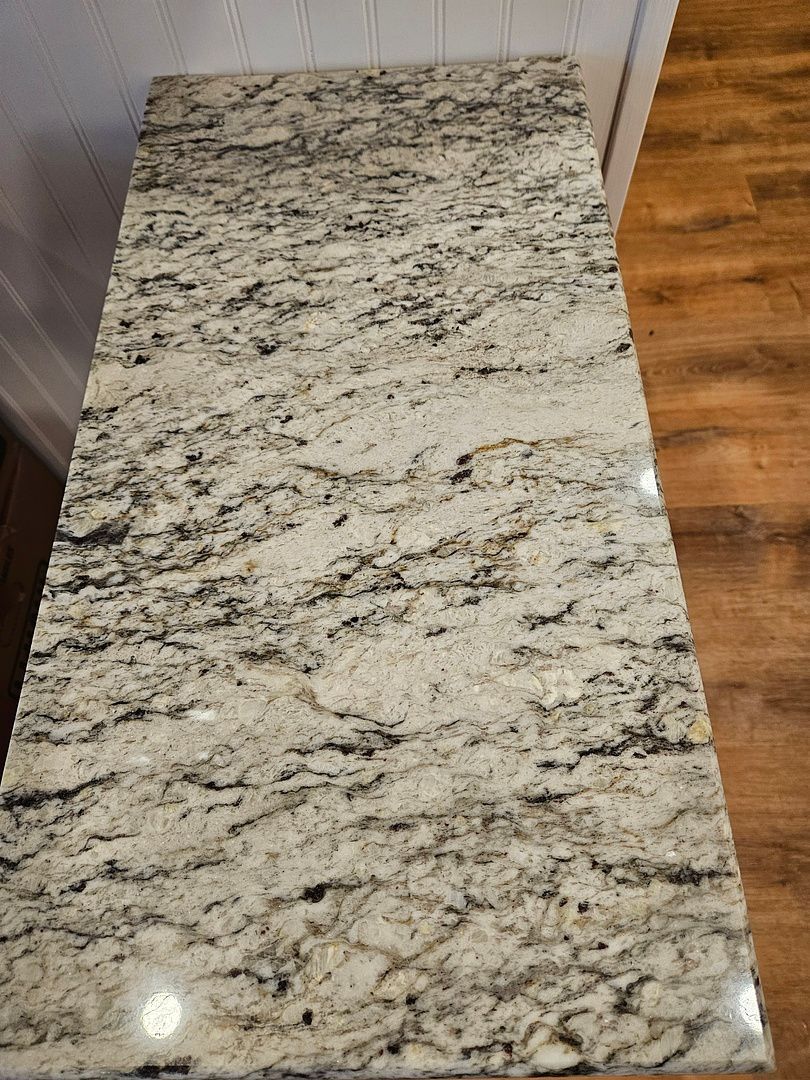A kitchen with wooden cabinets and granite counter tops.