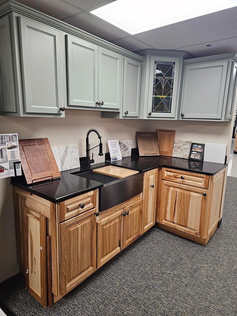 A kitchen with wooden cabinets , granite counter tops , and a sink.