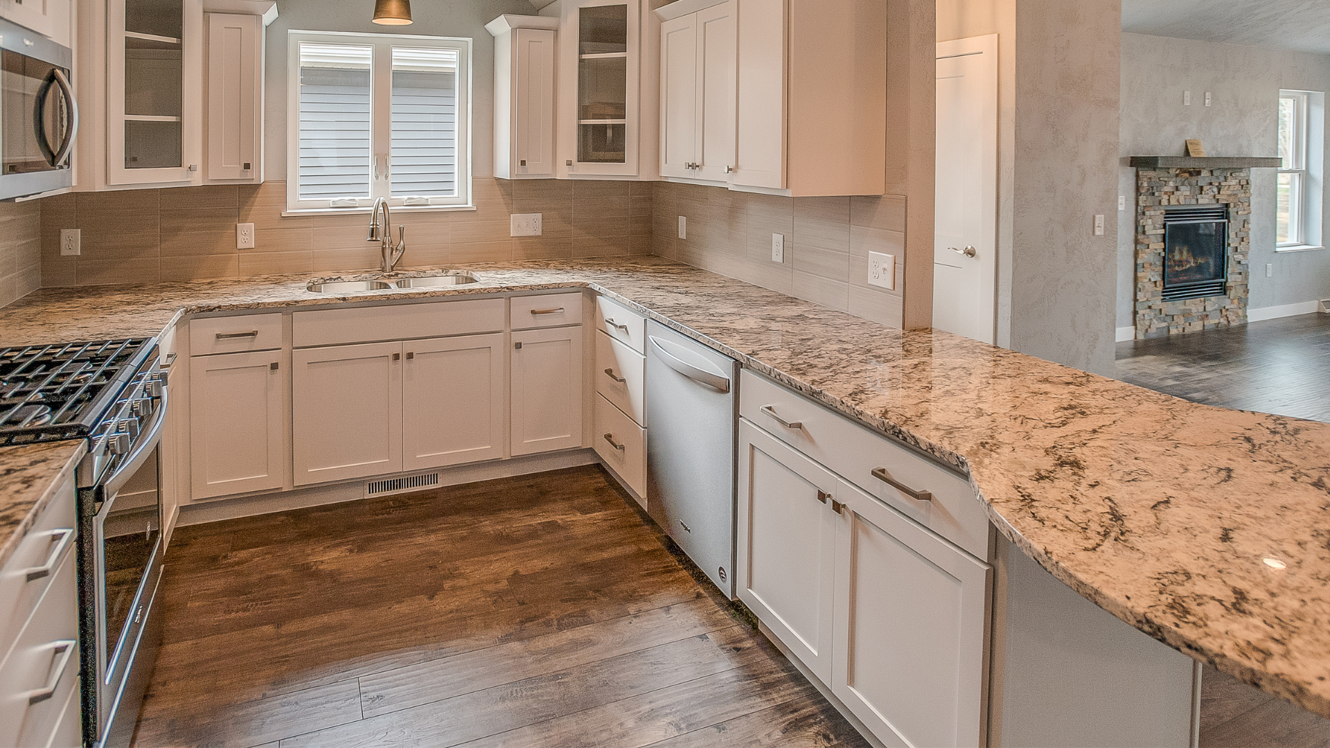 A kitchen with stainless steel appliances and granite counter tops.