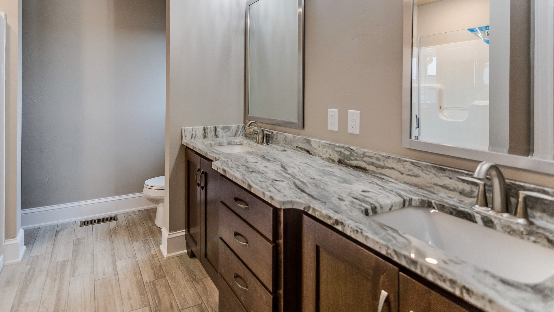 A kitchen with stainless steel appliances and granite counter tops.