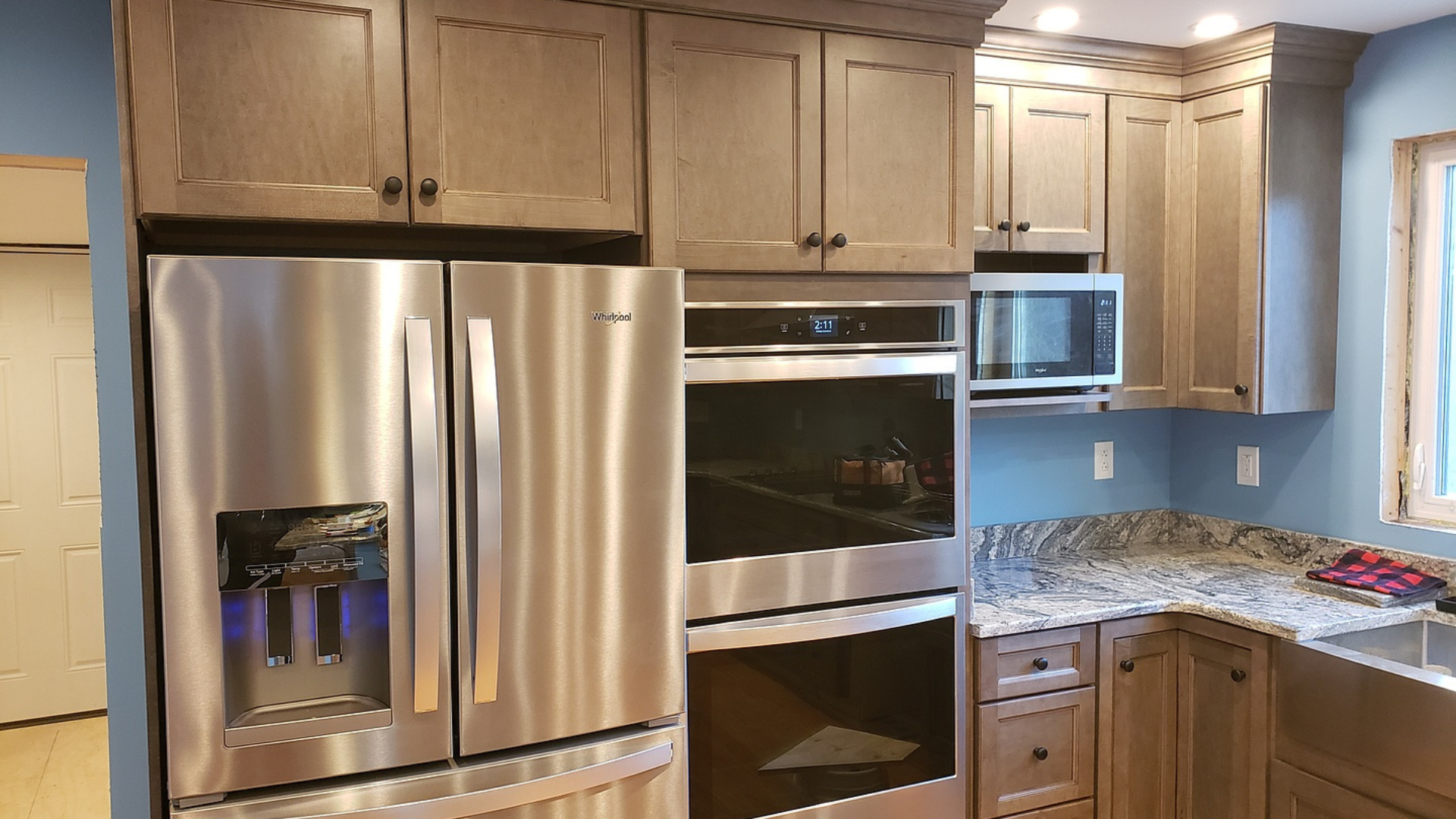 A kitchen with stainless steel appliances and granite counter tops.