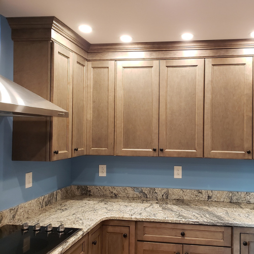 A kitchen with wooden cabinets and granite counter tops