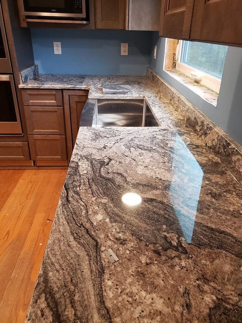 A kitchen with stainless steel appliances and a sink.