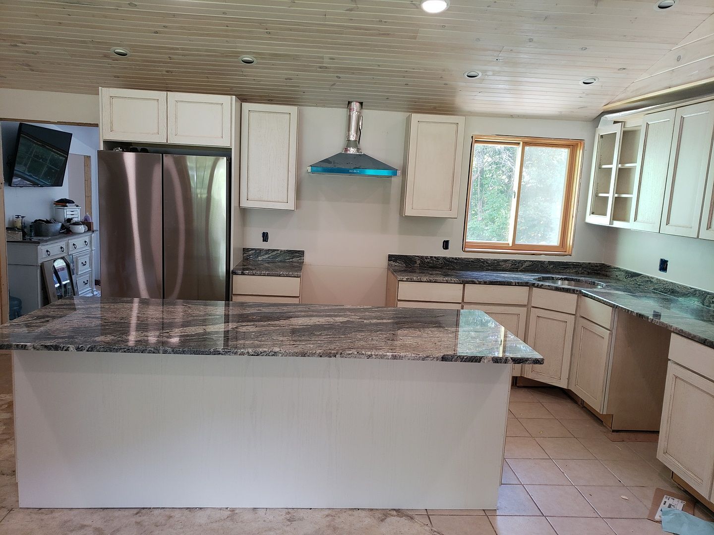 A kitchen with stainless steel appliances and granite counter tops.