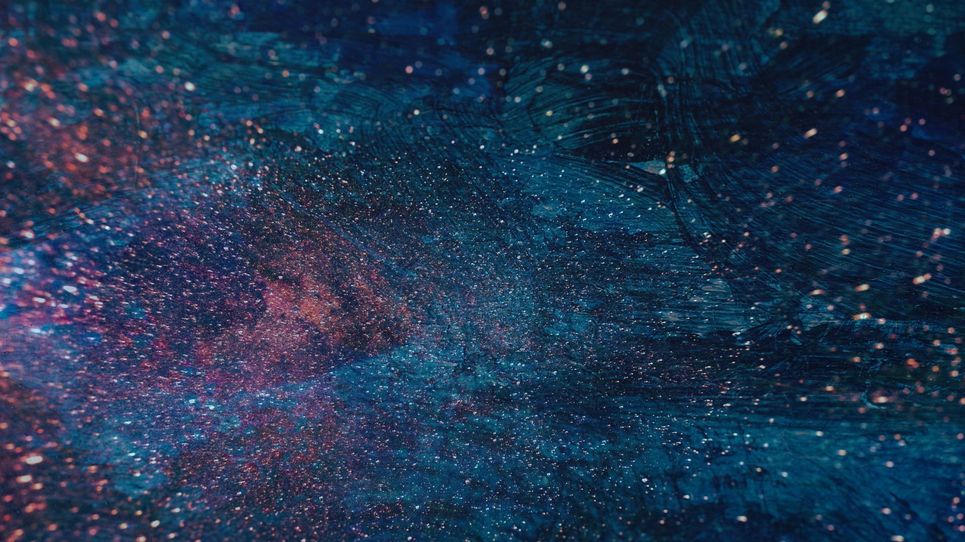 Dark blue and purple cosmic scene with scattered white and red speckles.