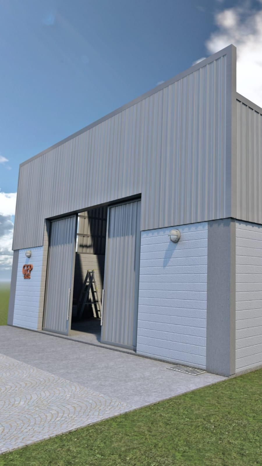 Hangar de metal gris con puertas abiertas, base de ladrillo blanco y césped verde bajo un cielo azul.