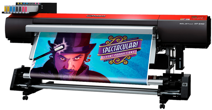 A large printer with a picture of a man in a top hat on it.